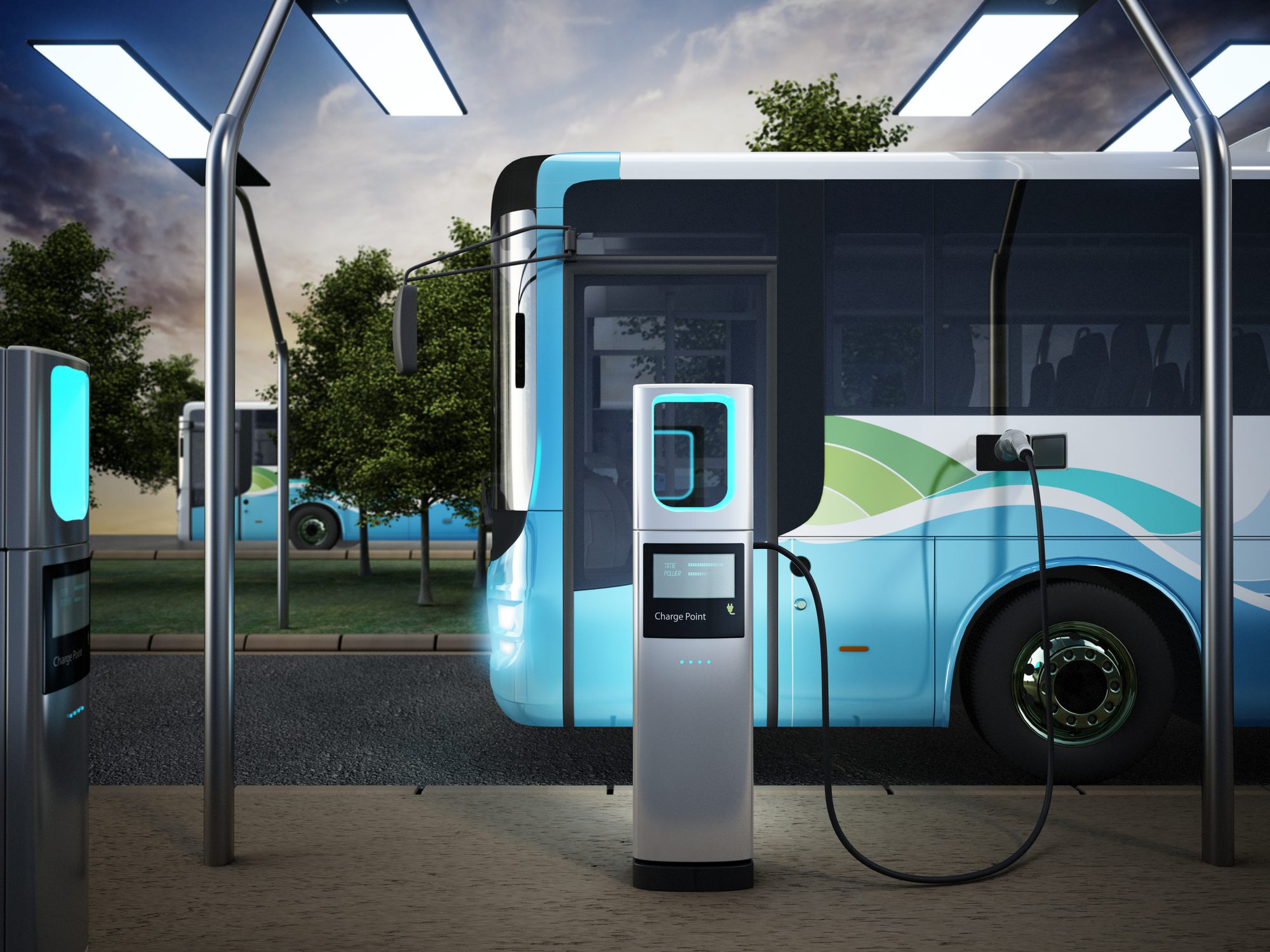 Electric city bus recharging at the bus charge station, connected with a power cable.